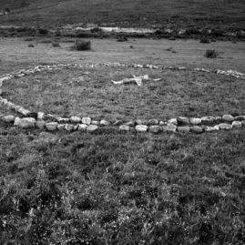 Rock circle on a grass veld - land art by Annie le Roux